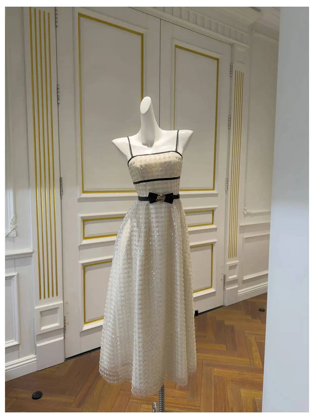 Strapless sequin midi dress displayed in an interior setting