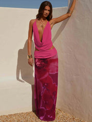 Woman wearing a deep V-neck cowl neck pink top and a floral print maxi skirt outdoors.