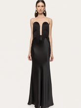 Black evening gown with cut-out design on a white background