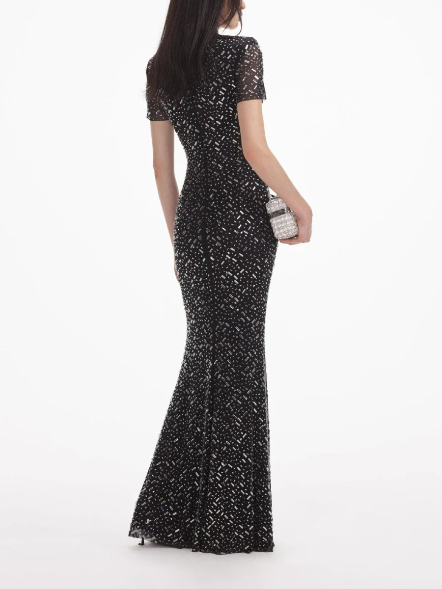 Black beaded evening gown on a white background
