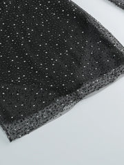 Black fabric with silver sequins on a white background