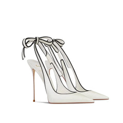 White high-heeled shoes with ribbon ties on a white background