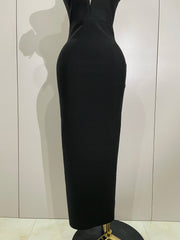 Black dress on a mannequin against a plain background