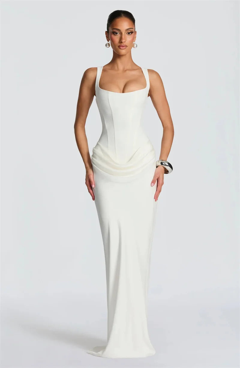 Woman wearing a white evening gown against a plain background