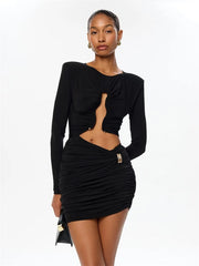 Woman wearing a black dress with cut-out design on a white background