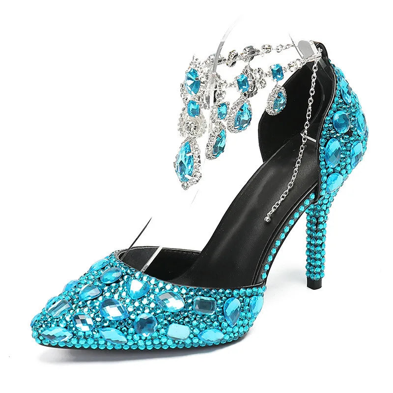 Black high-heeled shoe with turquoise gemstones and matching earrings on a white background