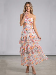 Model adjusting floral asymmetrical cut-out ruffle maxi dress in studio