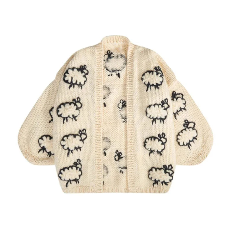 Knitted baby cardigan with sheep pattern on a white background