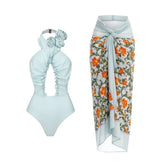 Pale blue floral one-piece swimsuit and matching cover-up skirt.