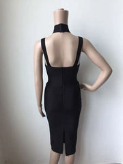 Black dress on a mannequin against a plain background