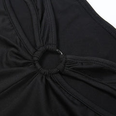 Close-up of a black swimsuit top with a knot detail on a white background