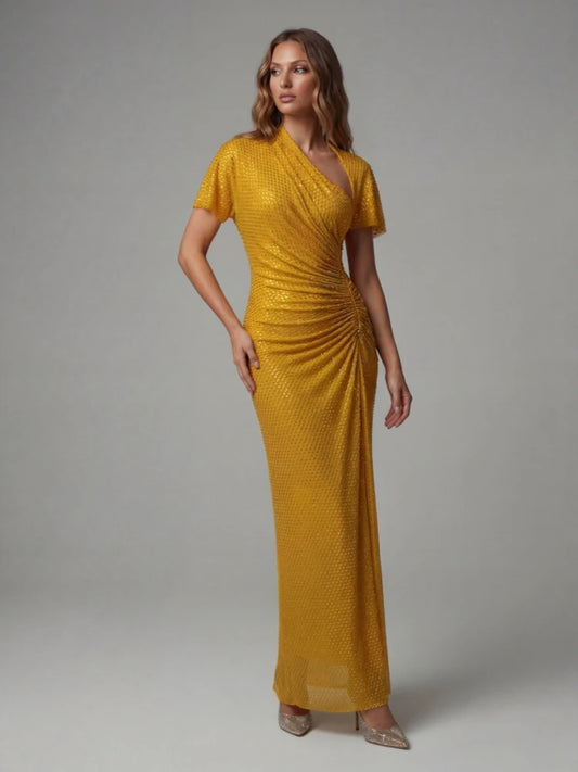 Woman wearing a mustard yellow dress against a gray background