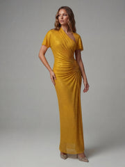 Woman wearing a mustard yellow dress against a gray background