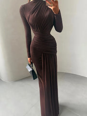 Person wearing a brown long-sleeve dress against a plain background