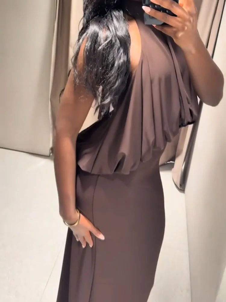 Person wearing a brown dress taking a mirror selfie.