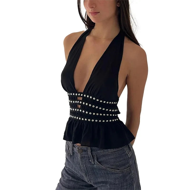 Black halter top with pearl details worn by a person on a white background