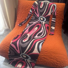 Colorful patterned dress on an orange textured chair