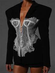 Black blazer with white lace detailing on a dark background