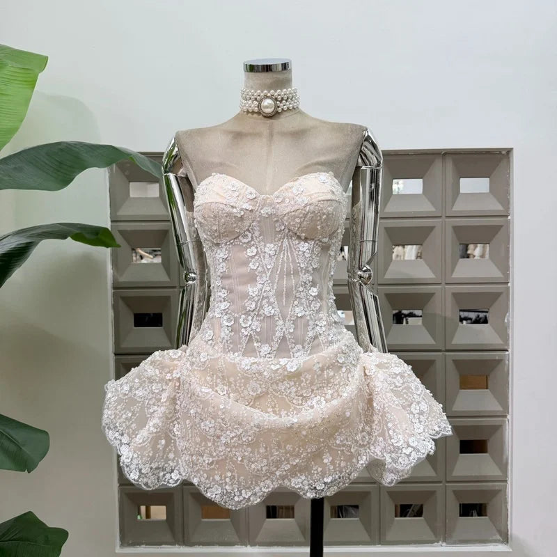 Ivory strapless floral lace mini dress with sequin embellishments.