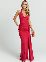 Woman wearing a red halter neck gown on a white background