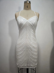 White sequin dress on a mannequin against a plain background