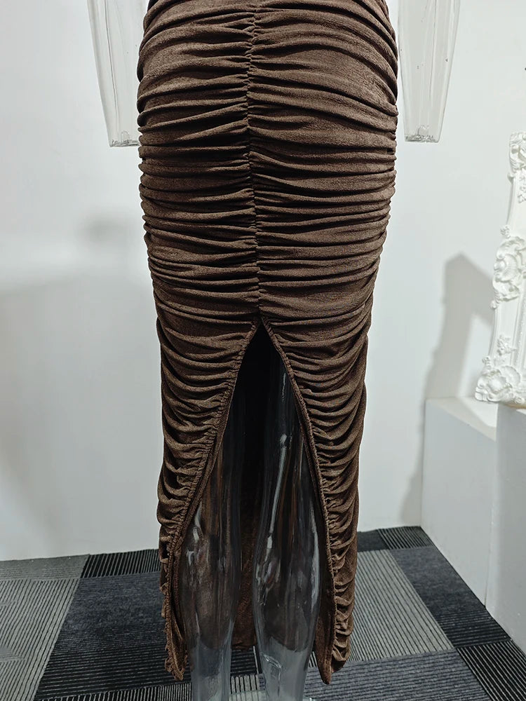 Brown ruched dress on a mannequin against a white wall.