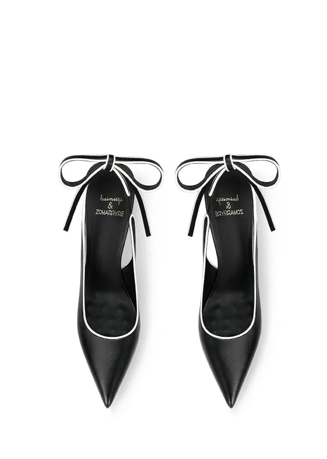 Black high-heeled shoes with bow details on a white background