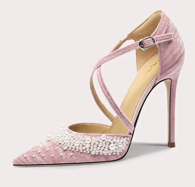 Pink high-heeled shoe with pearl details on a white background