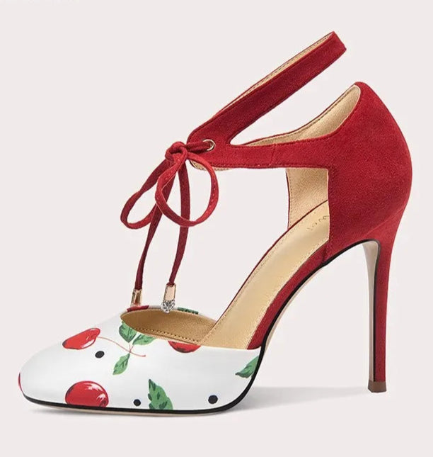 Red high-heeled shoe with floral pattern on a white background