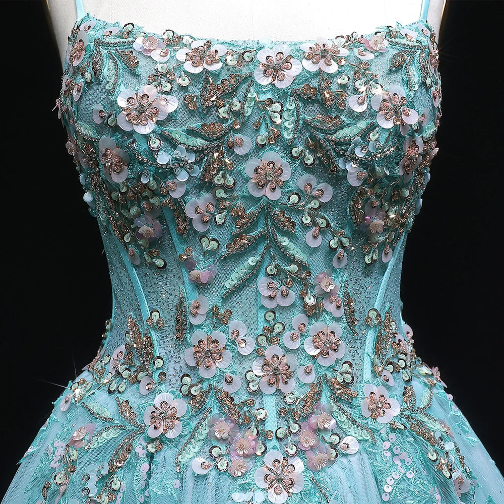 Teal evening gown with floral and bead embellishments on a black background