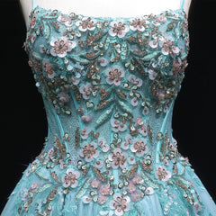 Teal evening gown with floral and bead embellishments on a black background