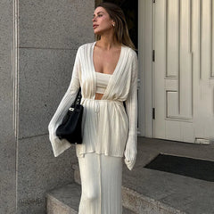 Woman in a white outfit standing outside a building