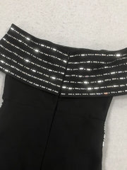 Black pants with reflective stripes on a light gray background