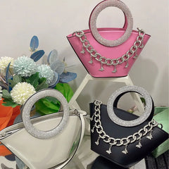 Collection of pink, white, and black crystal handle trapezoid tote bags