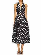 Black and white polka dot halter top and midi skirt set on a white background.