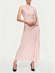 Woman wearing a pink draped dress on a white background