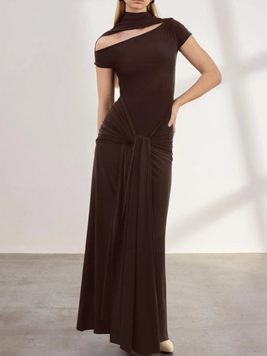 Woman wearing a brown evening gown against a plain background