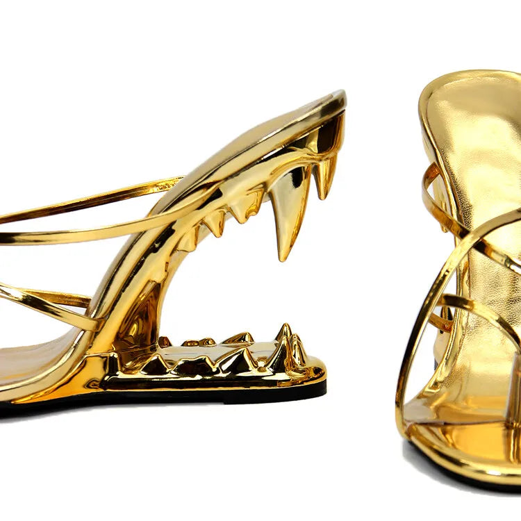 Gold high-heeled shoes with a unique design on a white background