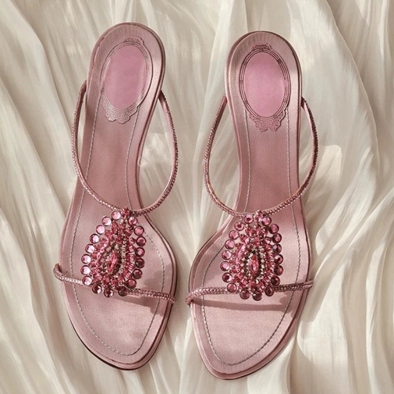 Pair of pink crystal embellished thin heel sandals.