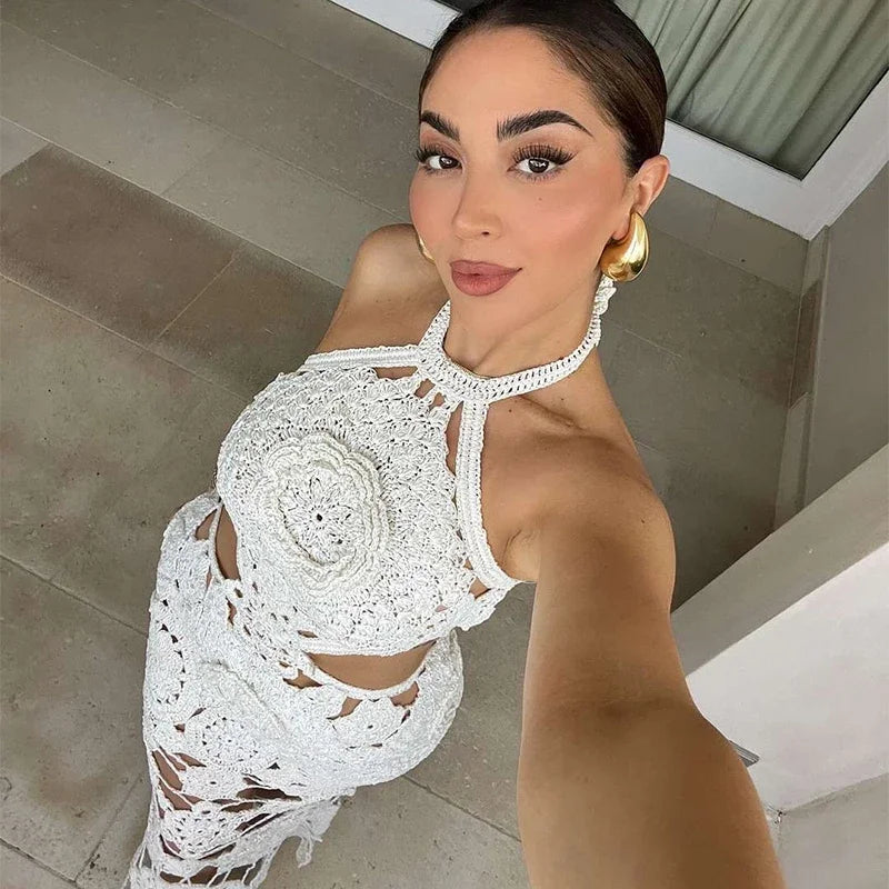 Woman wearing a white lace dress taking a selfie.