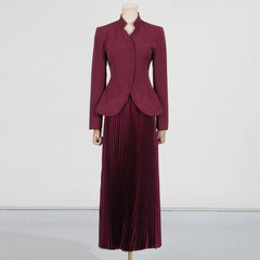 Maroon suit with a jacket and pleated skirt on a mannequin against a white background