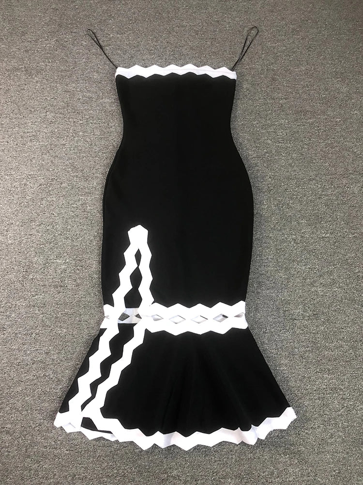 Black dress with white lace details on a gray surface
