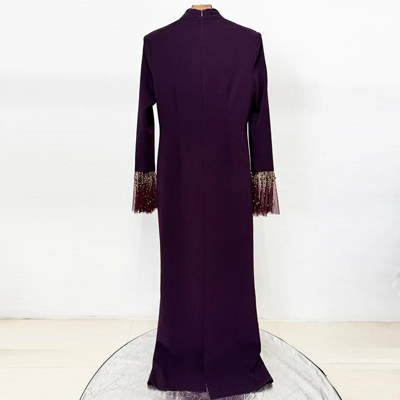 Back view of purple maxi dress with beaded neckline and flare sleeves