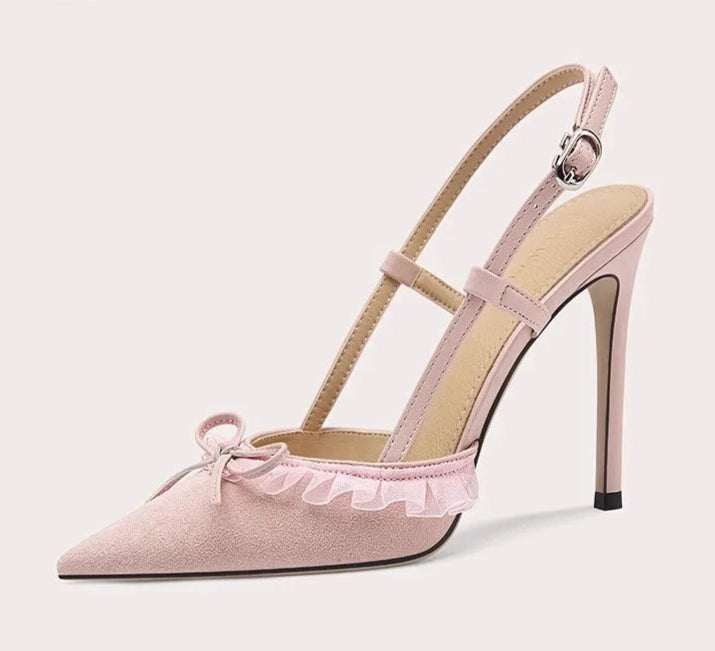 Pink high-heeled shoe with bow detail on a light gray background