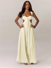 Woman wearing a white jumpsuit with cut-out design on a plain background