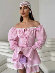 Woman wearing a pink off-shoulder dress with a white background
