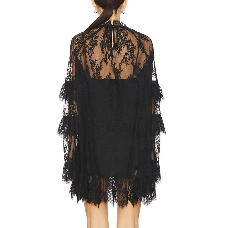 Black lace dress with sheer back on a white background