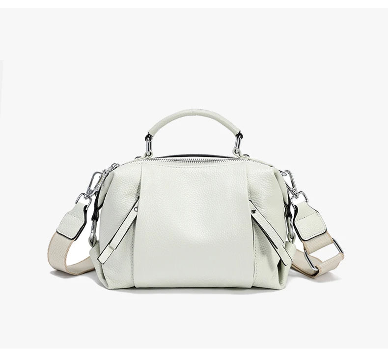 White handbag with a shoulder strap on a white background