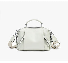 White handbag with a shoulder strap on a white background