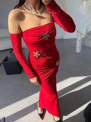 Red one-shoulder dress with gold embellishments worn by a person.